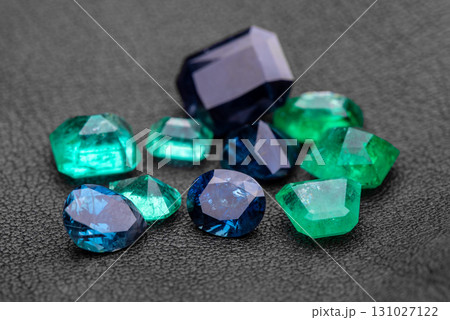 A collection of gemstones, including green, blue, and purple 131027122
