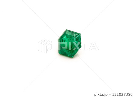A green gemstone is sitting on a white background 131027356