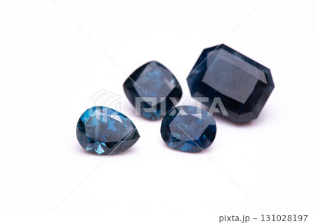 Four blue gemstones are displayed on a white background Four blue gemstones are displayed on a white background 131028197