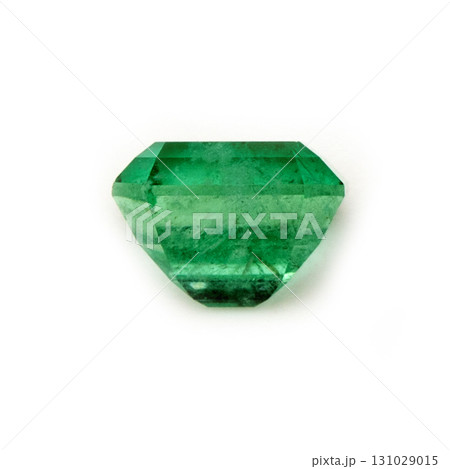 A green gemstone is sitting on a white background A green gemstone is sitting on a white background 131029015