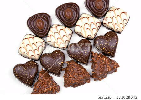 A row of chocolate truffles with hearts on them A row of chocolate truffles with hearts on them 131029042