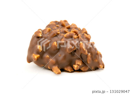 A piece of chocolate with nuts on top A piece of chocolate with nuts on top 131029047