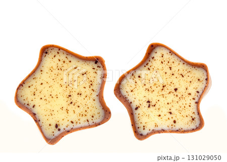 Two chocolate covered star shaped cookies with brown spots 131029050
