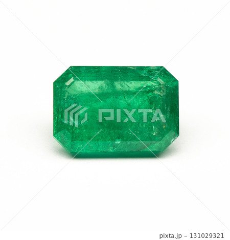 A green gemstone is sitting on a white background A green gemstone is sitting on a white background 131029321