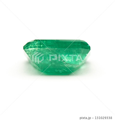 A green gemstone is sitting on a white background 131029338