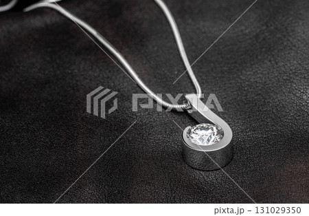 A silver necklace with a large diamond pendant 131029350