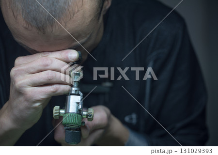 A man is looking through a magnifying glass A man is looking through a magnifying glass 131029393