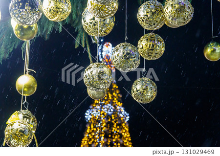 Decorated Christmas tree with multi-colored lights at night 131029469