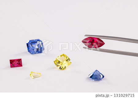 A close up of a diamond ring with a diamond cutter in the foreground A close up of a diamond ring with a diamond cutter in the foreground 131029715