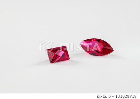Two red gemstones are shown side by side on a white background 131029719