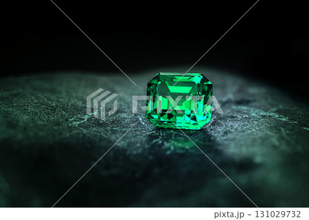 A green gemstone sits on a rock A green gemstone sits on a rock 131029732