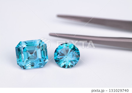 Two blue gems are on a white background Two blue gems are on a white background 131029740