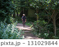 緑に包まれた小道を歩く人　A Person Walking in Forest Silence 131029844