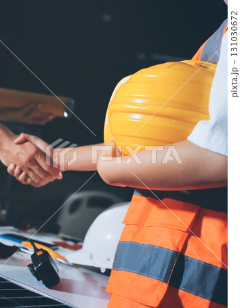 Closeup of team of industrial engineers meeting analyze machinery blueprints consult project on table in manufacturing factory. Working in manufacturing plant or production plant. 131030672