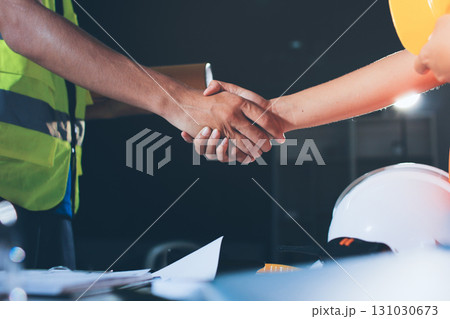 Closeup of team of industrial engineers meeting analyze machinery blueprints consult project on table in manufacturing factory. Working in manufacturing plant or production plant. 131030673