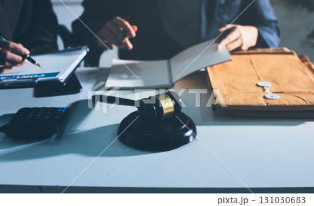 Lawyer explained to the client about the law that must be brought against the court case. Lawyer explained to the client about the law that must be brought against the court case. 131030683