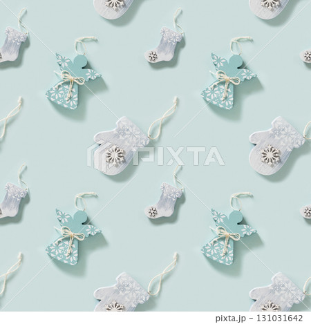 Seamless pattern of Christmas carved wooden figurines angels and mitten on blue background. Xmas abstract background. Texture for print. Seamless pattern of Christmas carved wooden figurines angels and mitten on blue background. Xmas abstract background. Texture for print. 131031642