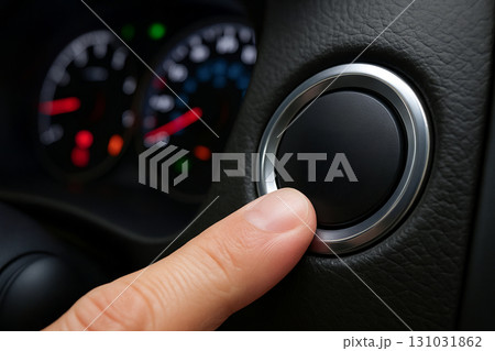 Close-up of hand pressing start button in modern car with dashboard displaying speedometers. concept of convenience, automotive technology, vehicle start system 131031862