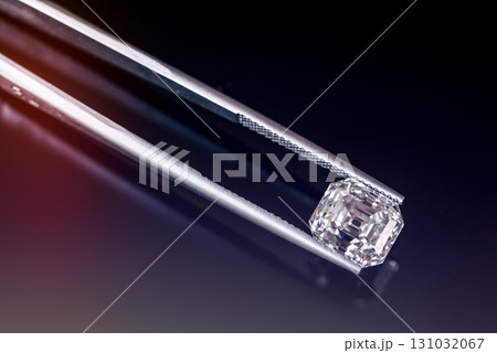 A diamond is displayed in a jeweler's magnifying glass 131032067