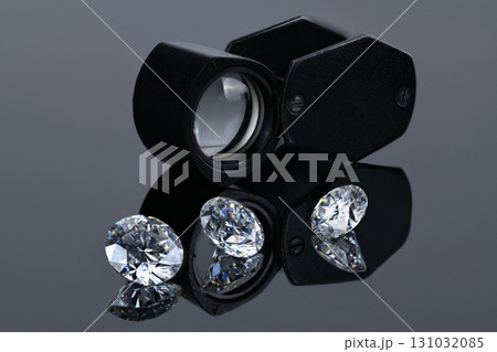 A close up of three diamonds with a magnifying glass A close up of three diamonds with a magnifying glass 131032085