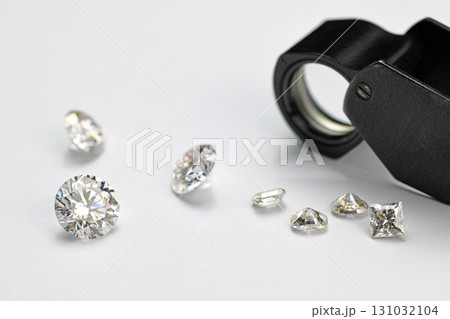 Diamonds and Jewelry Loupe on White Background 131032104
