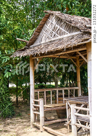 Rustic bamboo hut surrounded by lush greenery in a serene tropical setting Rustic bamboo hut surrounded by lush greenery in a serene tropical setting 131032272