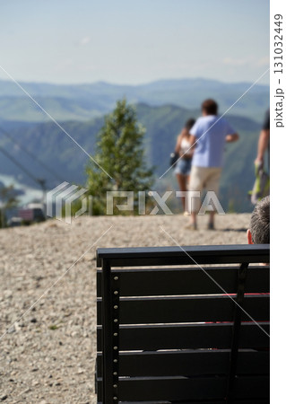 Outdoor mountain view with caucasian adults and teens enjoying scenic landscape Outdoor mountain view with caucasian adults and teens enjoying scenic landscape 131032449