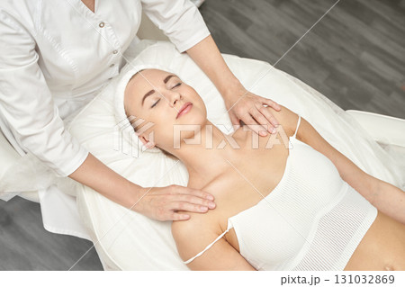 Female caucasian adult receiving relaxing shoulder and neck massage in spa 131032869