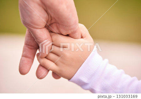 Caucasian elderly male hand holding caucasian child hand in outdoor setting 131033169