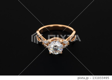 A gold and diamond ring with a large diamond in the center A gold and diamond ring with a large diamond in the center 131033495