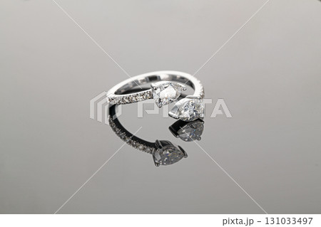 A ring with two diamonds and a diamond band 131033497