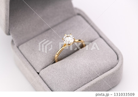 A gold and white diamond ring is in a box A gold and white diamond ring is in a box 131033509