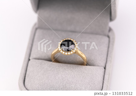 A gold and black ring with diamonds 131033512