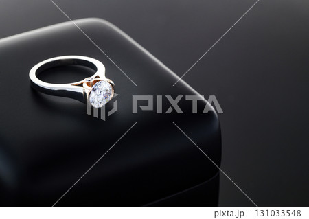 A diamond ring is sitting on a black box 131033548