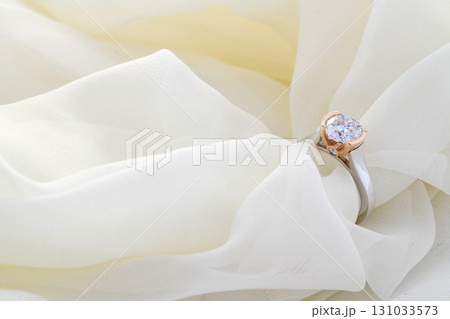 A white cloth with a diamond ring on it A white cloth with a diamond ring on it 131033573