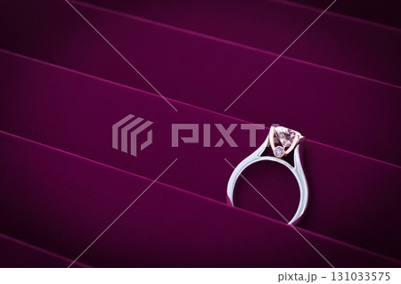 A diamond ring is on a purple background A diamond ring is on a purple background 131033575