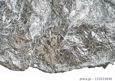 Close-up of crumpled aluminum foil texture with reflective silver surface Close-up of crumpled aluminum foil texture with reflective silver surface 131033640