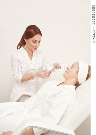 Caucasian female beauty treatment session with skincare expert in spa setting 131033689