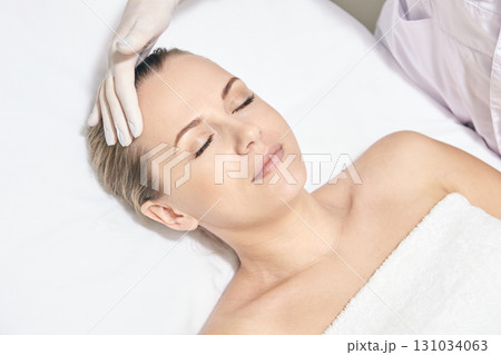 Caucasian female receiving facial treatment at spa with comfortable relaxation Caucasian female receiving facial treatment at spa with comfortable relaxation 131034063