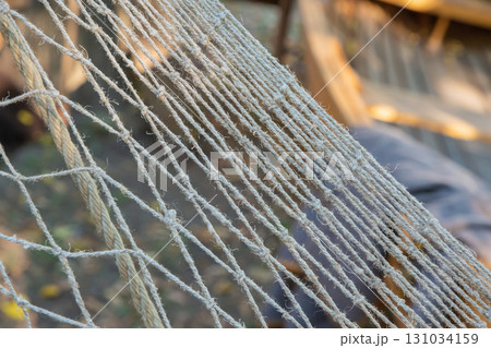 natural fishing net close-up, linen weaving, traditional way of fishing natural fishing net close-up, linen weaving, traditional way of fishing 131034159