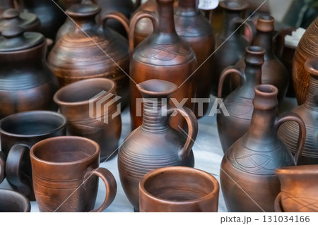handmade earthenware pots and jug close-up, traditional tableware production 131034166