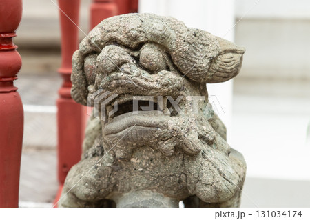 stone sculpture lion in chinese style close-up on the blurred background of the temple 131034174