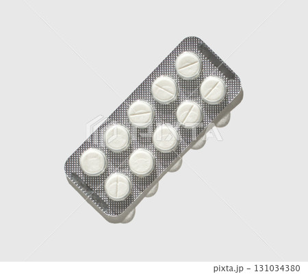 Blister pack of circular white tablets on gray background Blister pack of circular white tablets on gray background 131034380