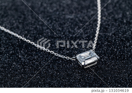 A silver necklace with a diamond pendant 131034619