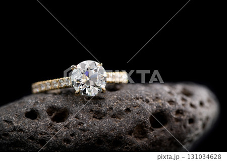 A diamond ring is on a rock A diamond ring is on a rock 131034628