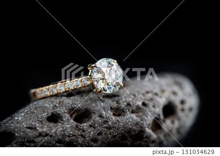 A diamond ring is on a rock 131034629