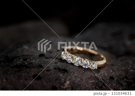 A gold and diamond ring with five diamonds on it A gold and diamond ring with five diamonds on it 131034631