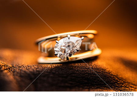 Engagement Diamond Ring on Golden Yellow Light background 131036578