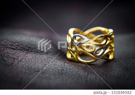 Gold Jewelry Ring on Leather Background Gold Jewelry Ring on Leather Background 131036582