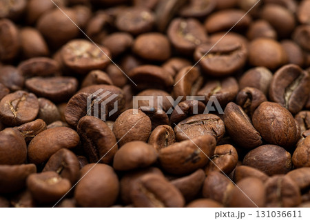 A close up of coffee beans with a grainy texture 131036611